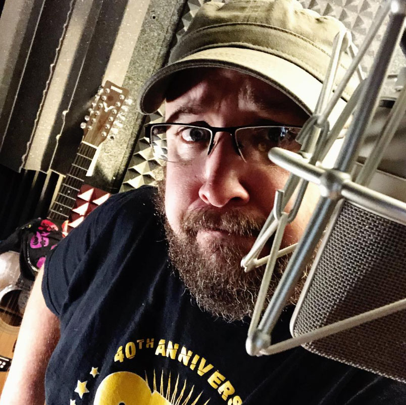 Bill Stage at the Neumann microphone in his home studio, ready to record a mobile app demo