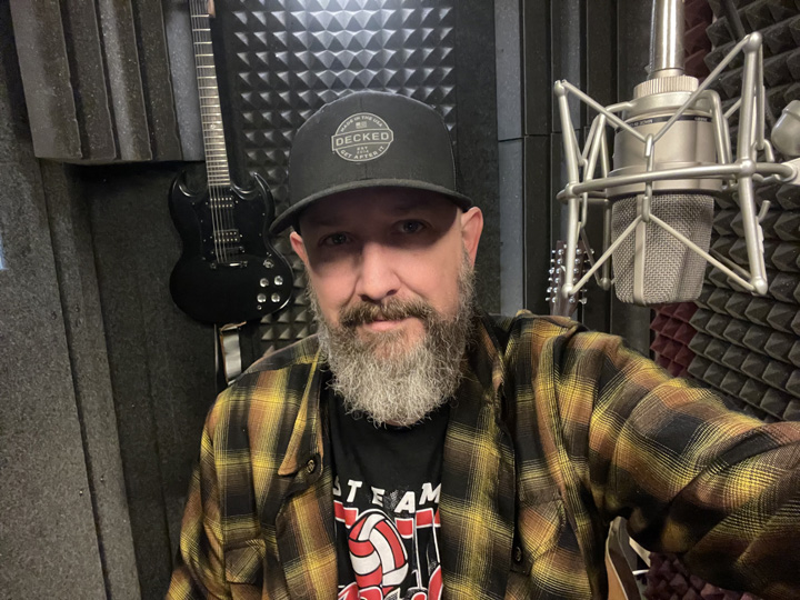 Bill Stage voice over artist recording in his home studio booth