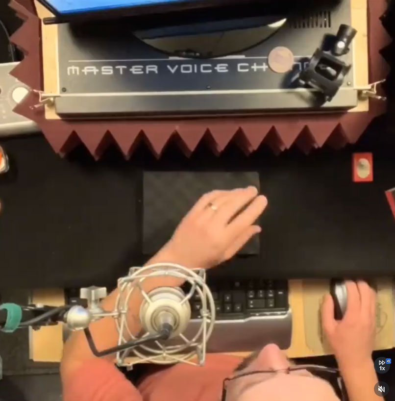 Bill Stage's hands on his recording gear mid-session in the voice over booth