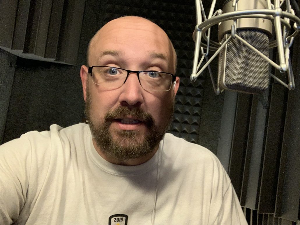 Bill Stage talking into the microphone in his voice over booth