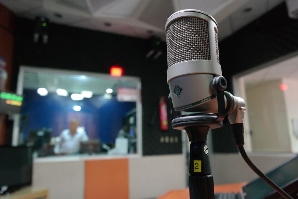 Studio microphone in a broadcast booth representing the radio to voice over transition for working voice over artists