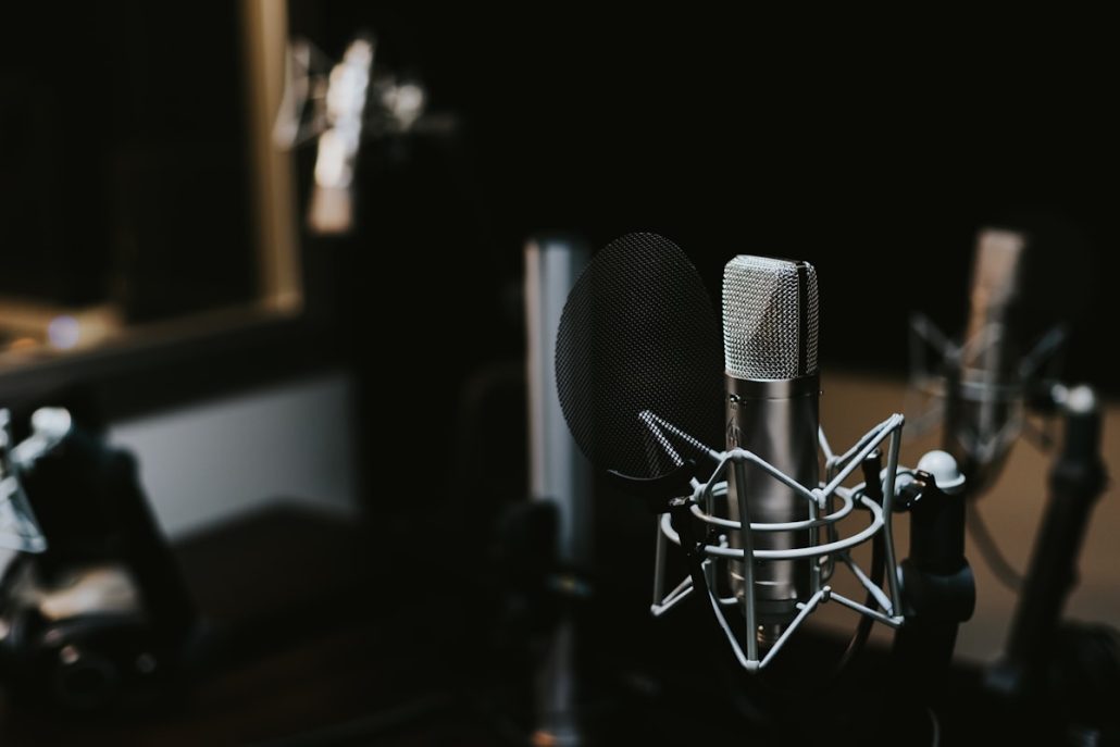 Professional broadcast microphone on a stand in a radio studio for commercial voice over recording