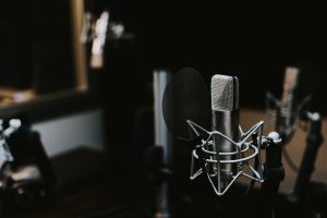 Professional broadcast microphone on a stand in a radio studio for commercial voice over recording