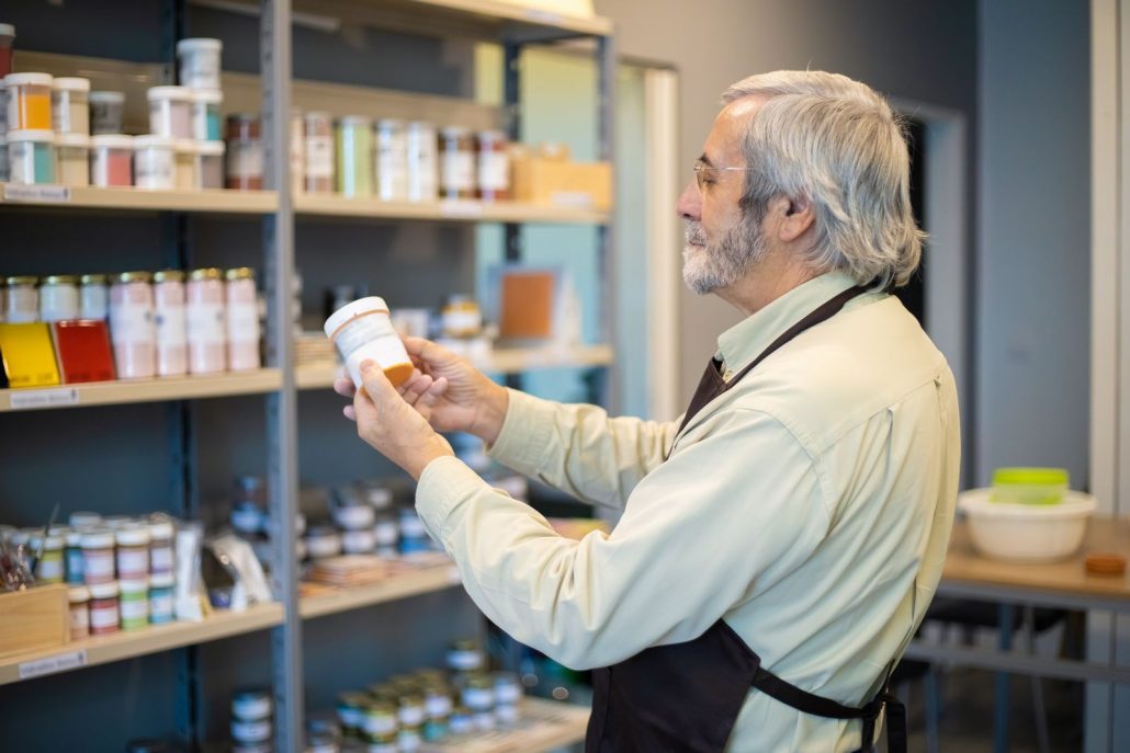 Store employee stocking paint at a hardware store, the kind of place where one consistent voice over artist makes a brand instantly familiar