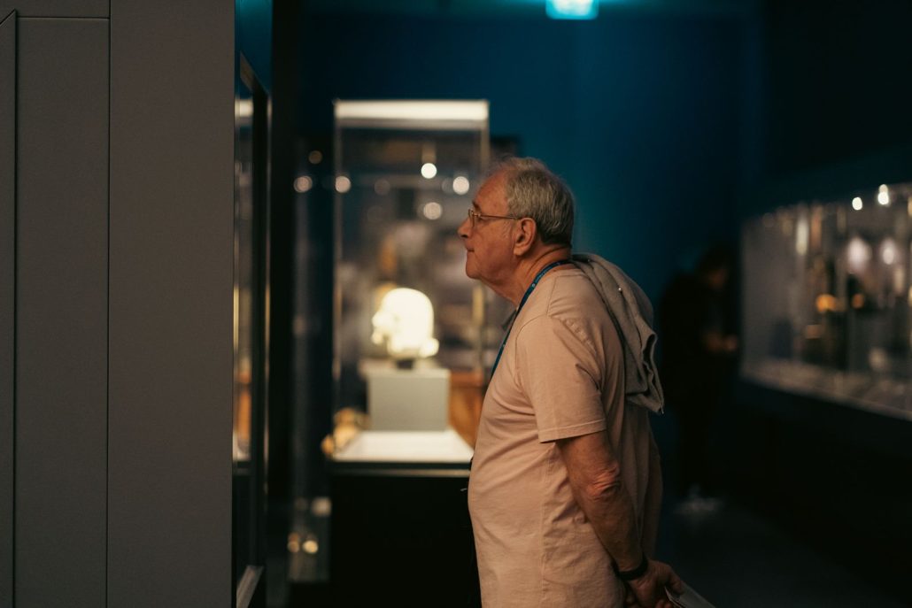 A lone museum visitor exploring an exhibit, the one listener voice over for museum audio tours is really talking to
