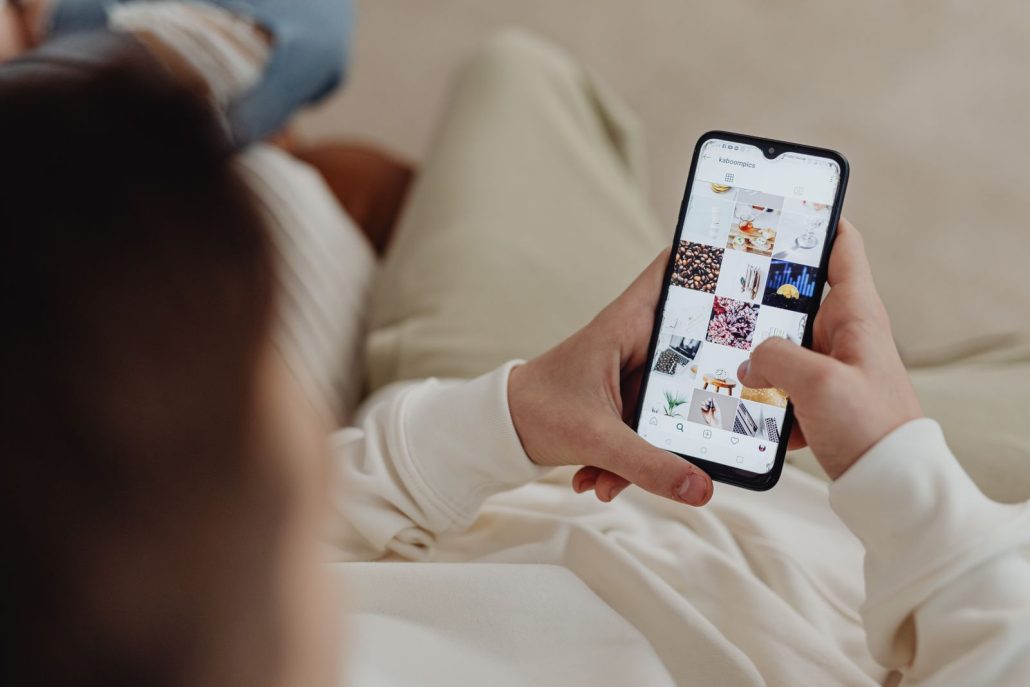 Person scrolling an Instagram feed on a phone, the three-second window voice over for social media video ads has to win
